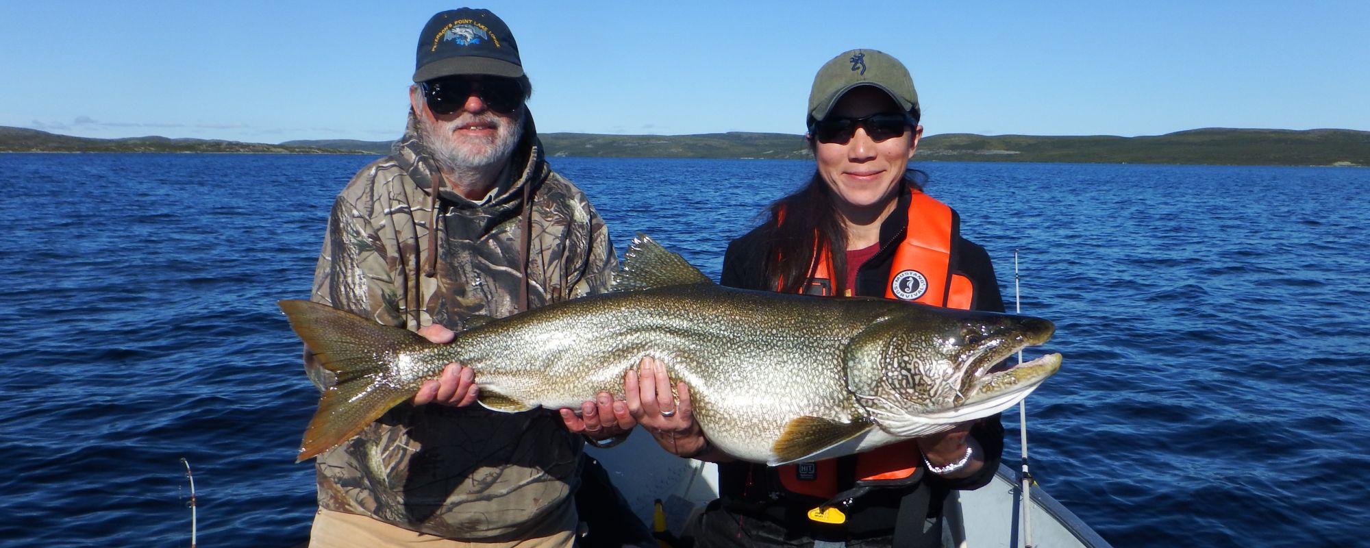 Two Anglers holding giant lake trout