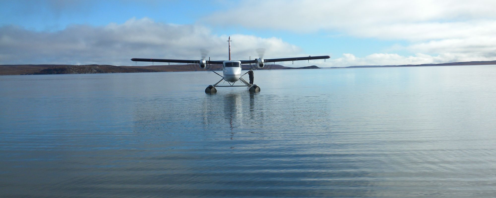 Twin Otter Float plane taxing on calm water